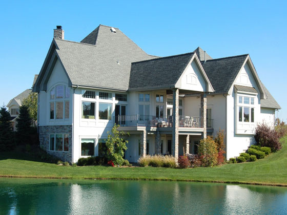 A large house next to water.