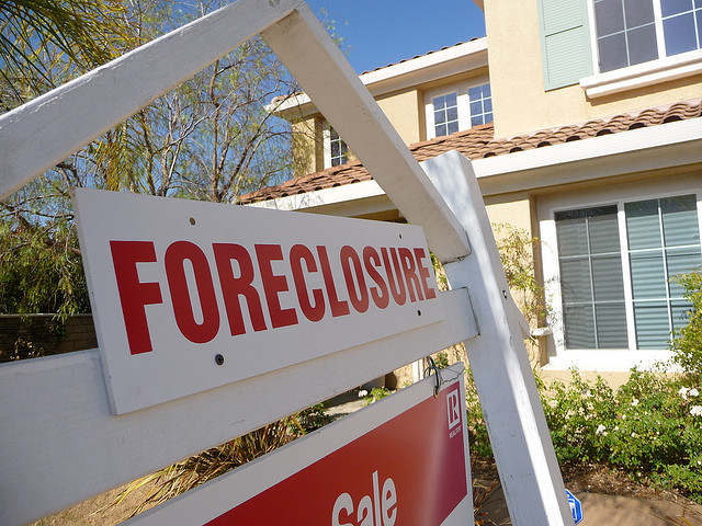 A house with a foreclosure sign in front from another Foreclosure Crisis