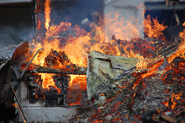 A house on fire due to a natural disaster. 