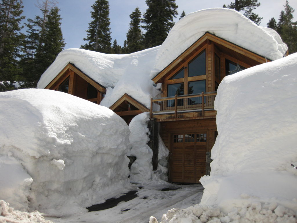 A house covered in snow that is prepared for winter.