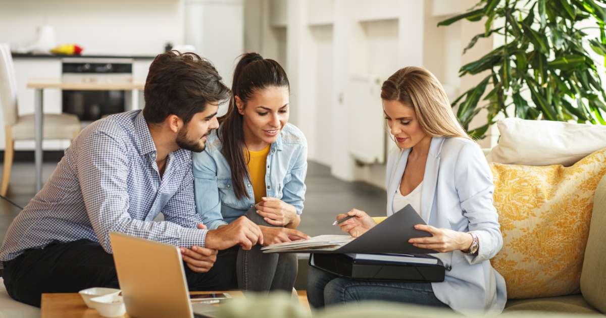couple speaking to real estate agent
